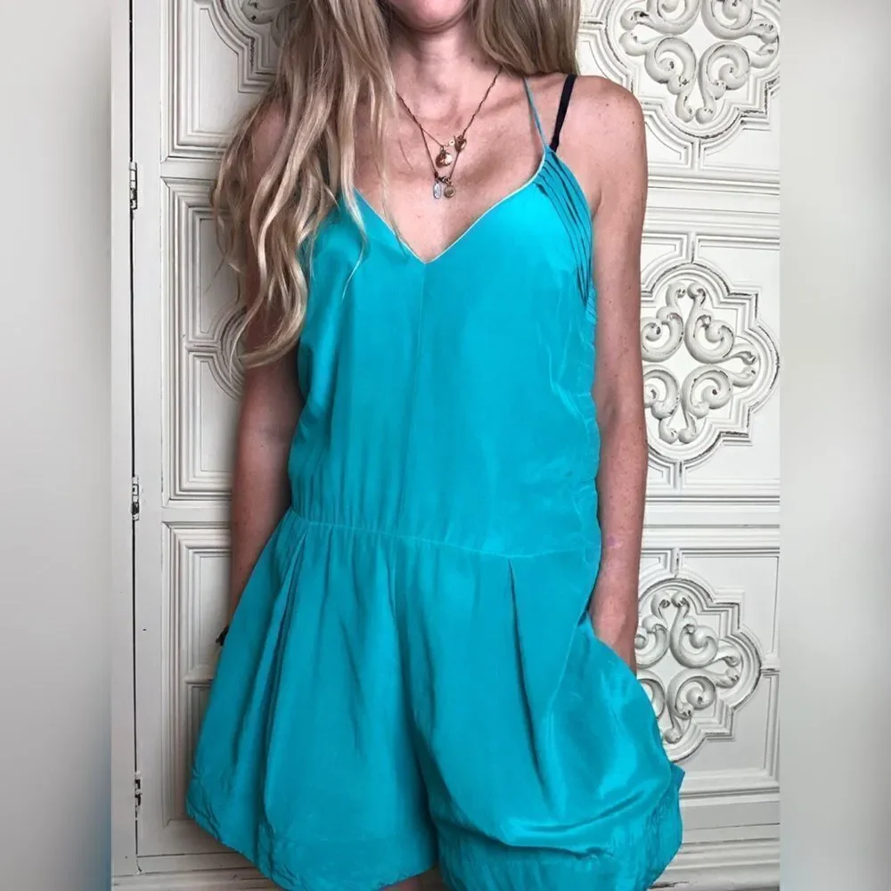 Turquoise wink romper with ruffle details size small